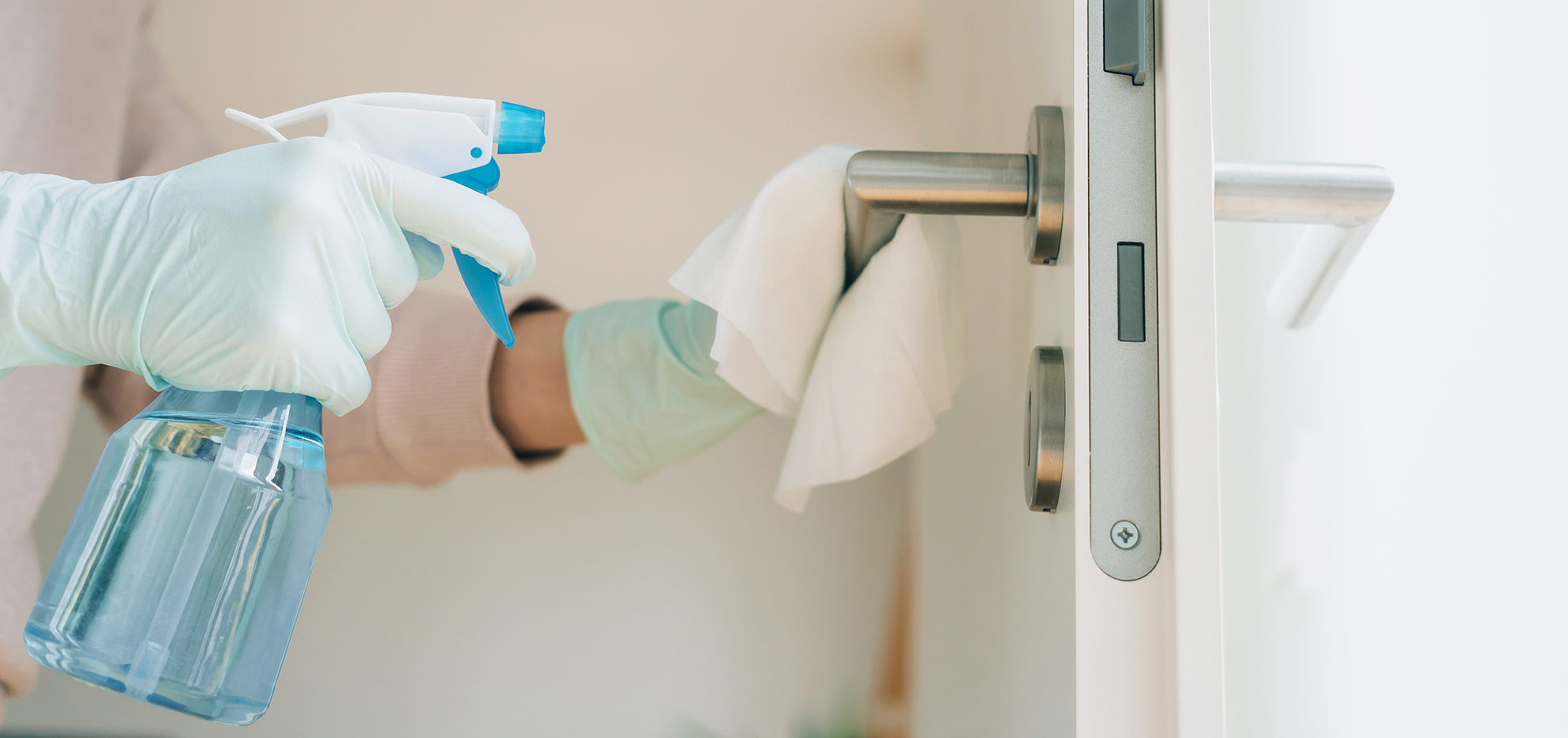 Disinfecting a door handle with Pudol surface disinfectant